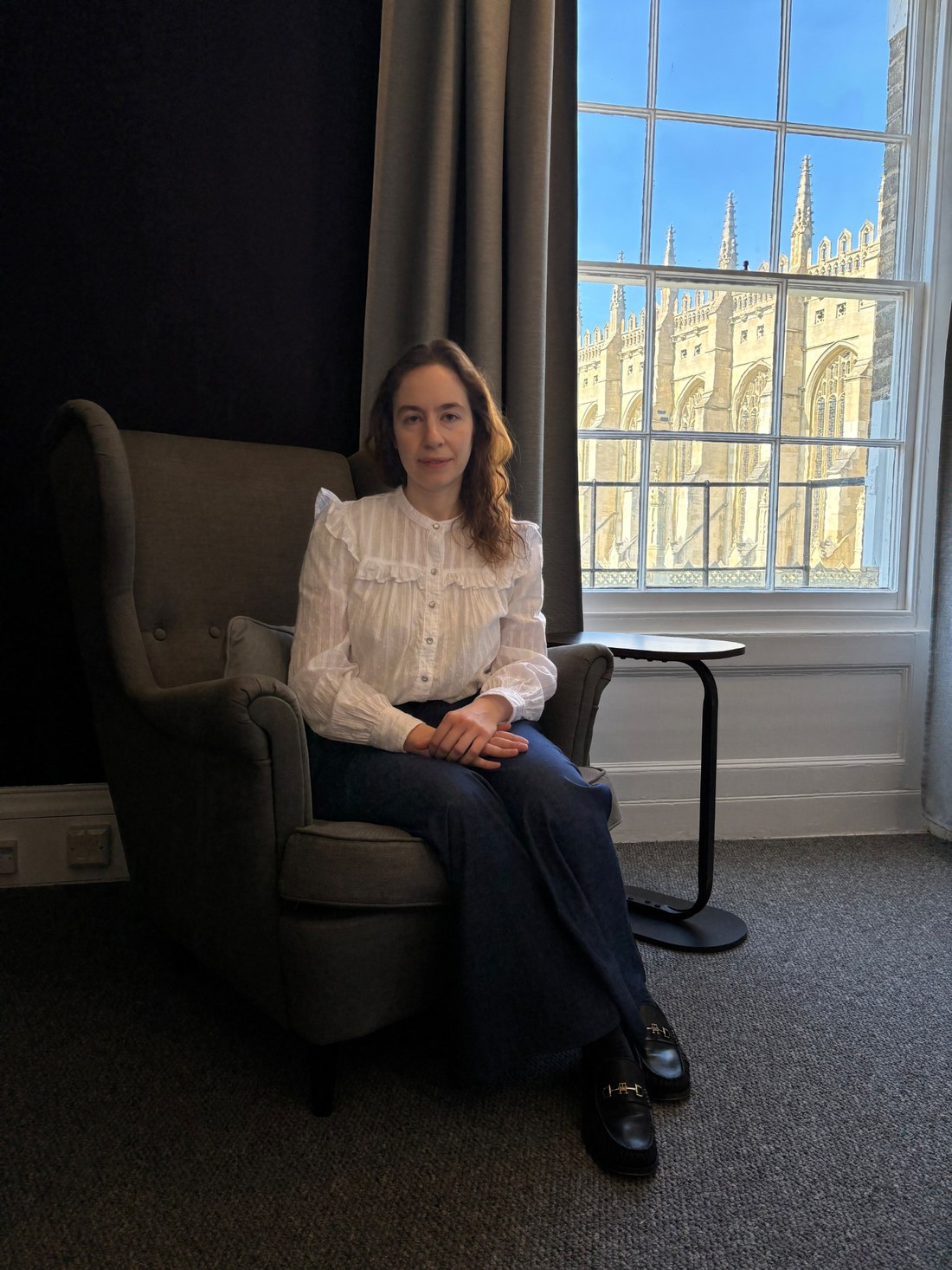 Dr Maria Valkovskaya seated in an armchair in her consulting room.
