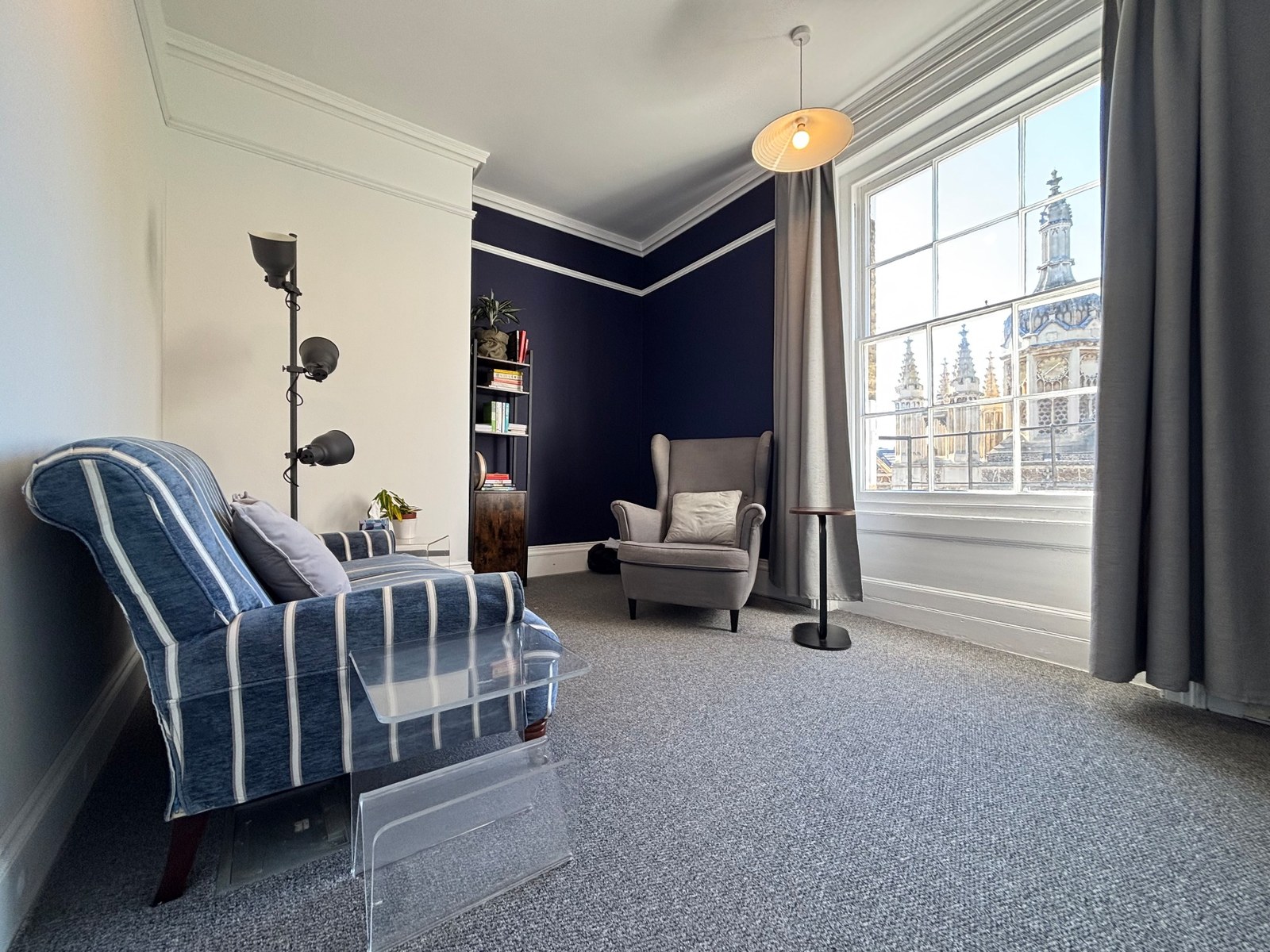 Full view of the therapy room with two chairs and a large window overlooking King's College.